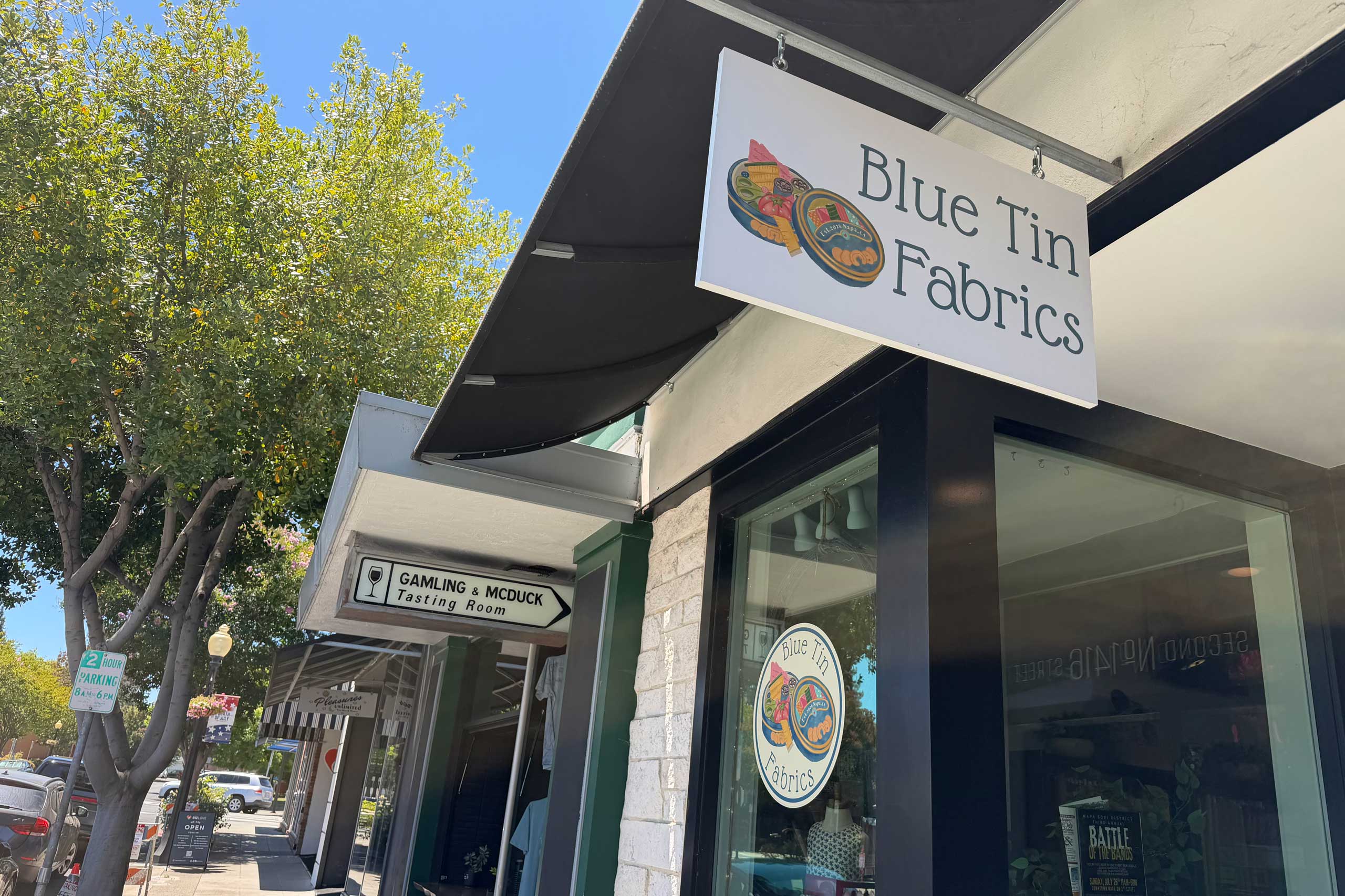 Blue Tin Fabrics hanging sign
